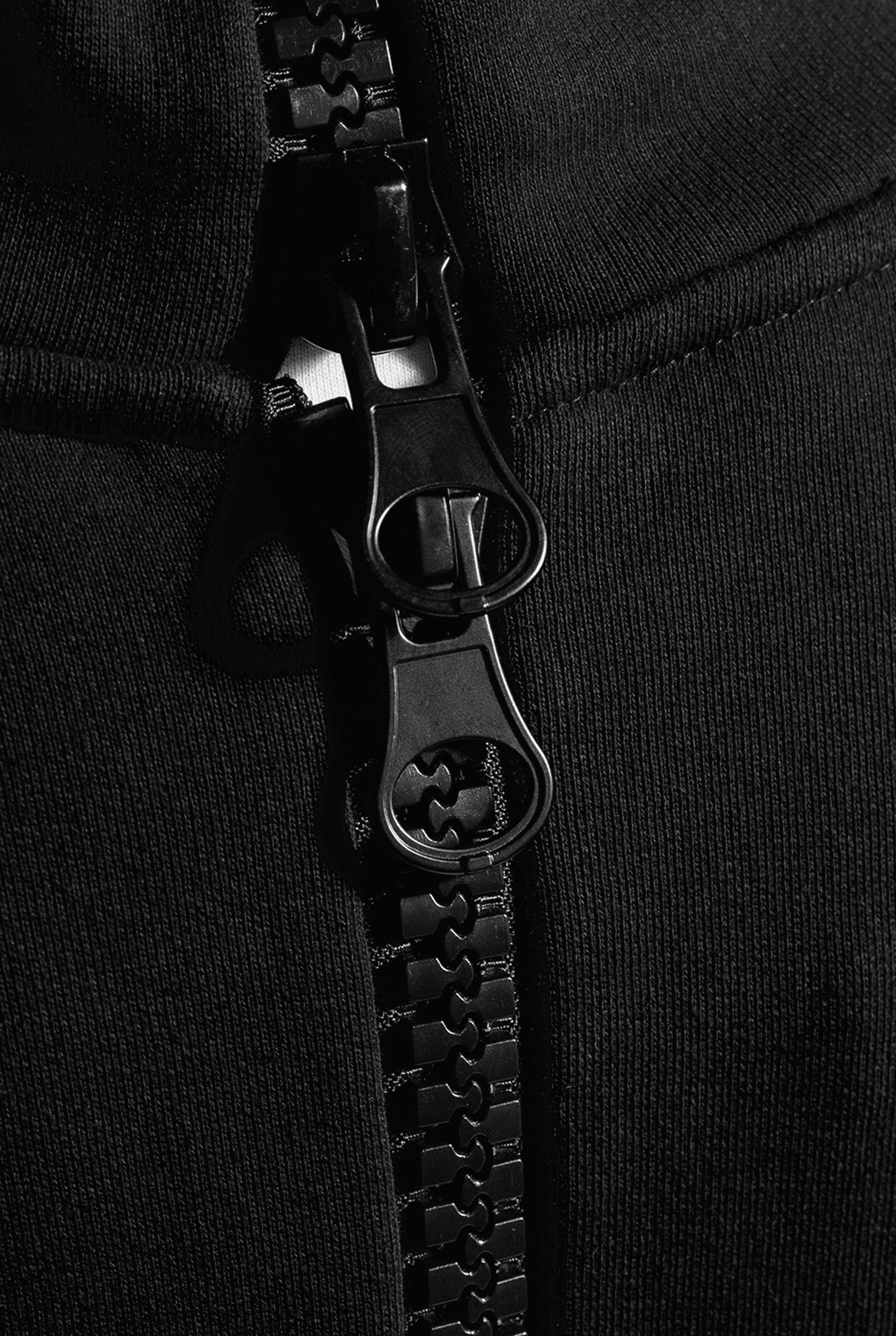 Close up of large black zippers on back of Astro Boy hoodie that meet at the base of the neck