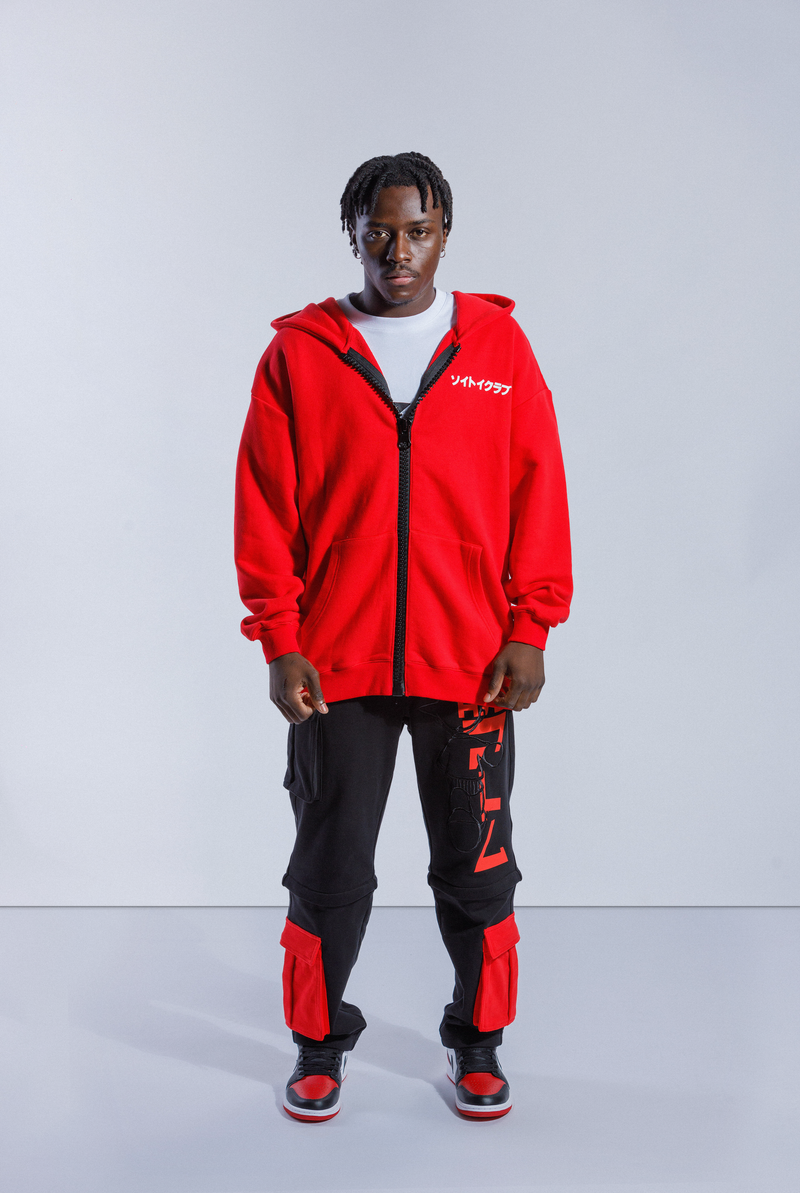 Model wearing Red Astro Boy hoodie with large black zip down the middle