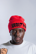 Model wearing Red Astro Boy beanie with embroidered Japanese text that reads 'ATOM BOY' - The original Astro Boy Logo