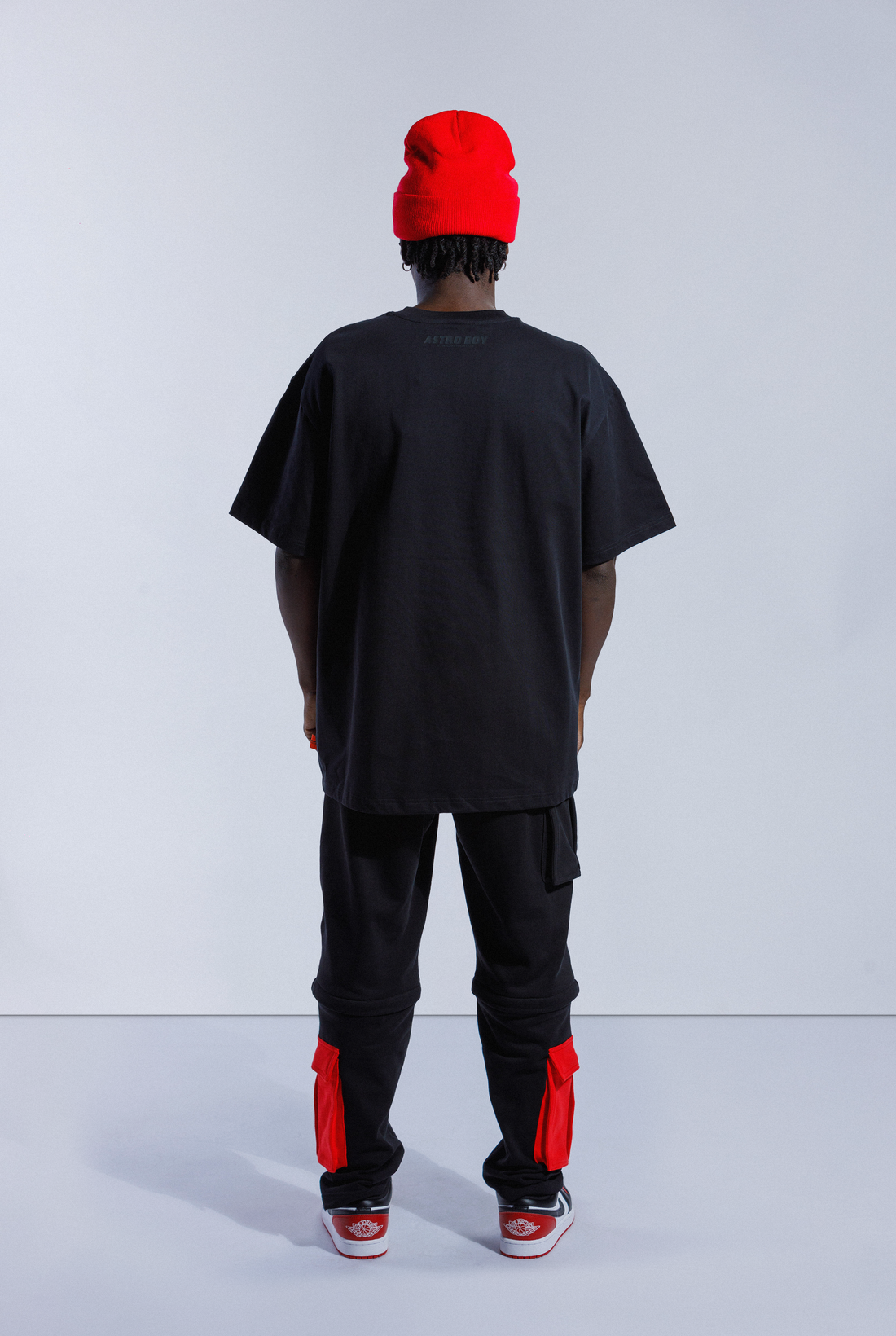 Model wearing black Astro Boy OG Box Logo tee. Tee has red box with Japanese 'SOYTOY CLUB' embroidered on the front with Astro Boy on top