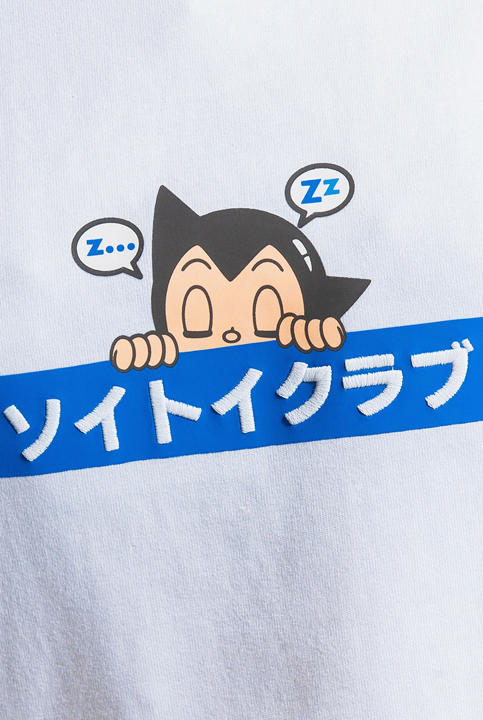 Close up of Astro Boy Sleepy Box Logo tee. Tee has blue box with Japanese 'SOYTOY CLUB' embroidered on the front with Astro Boy on top
