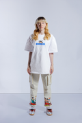 Model wearing white Astro Boy Sleepy Box Logo tee. Tee has blue box with Japanese 'SOYTOY CLUB' embroidered on the front with Astro Boy on top