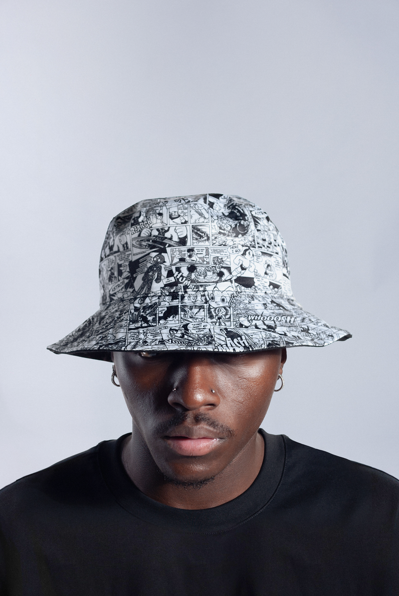 Model wearing reversible Astro Boy bucket hat with comic panel side out