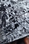 Close-up of Astro Boy comic book style pattern with black and white illustrations.