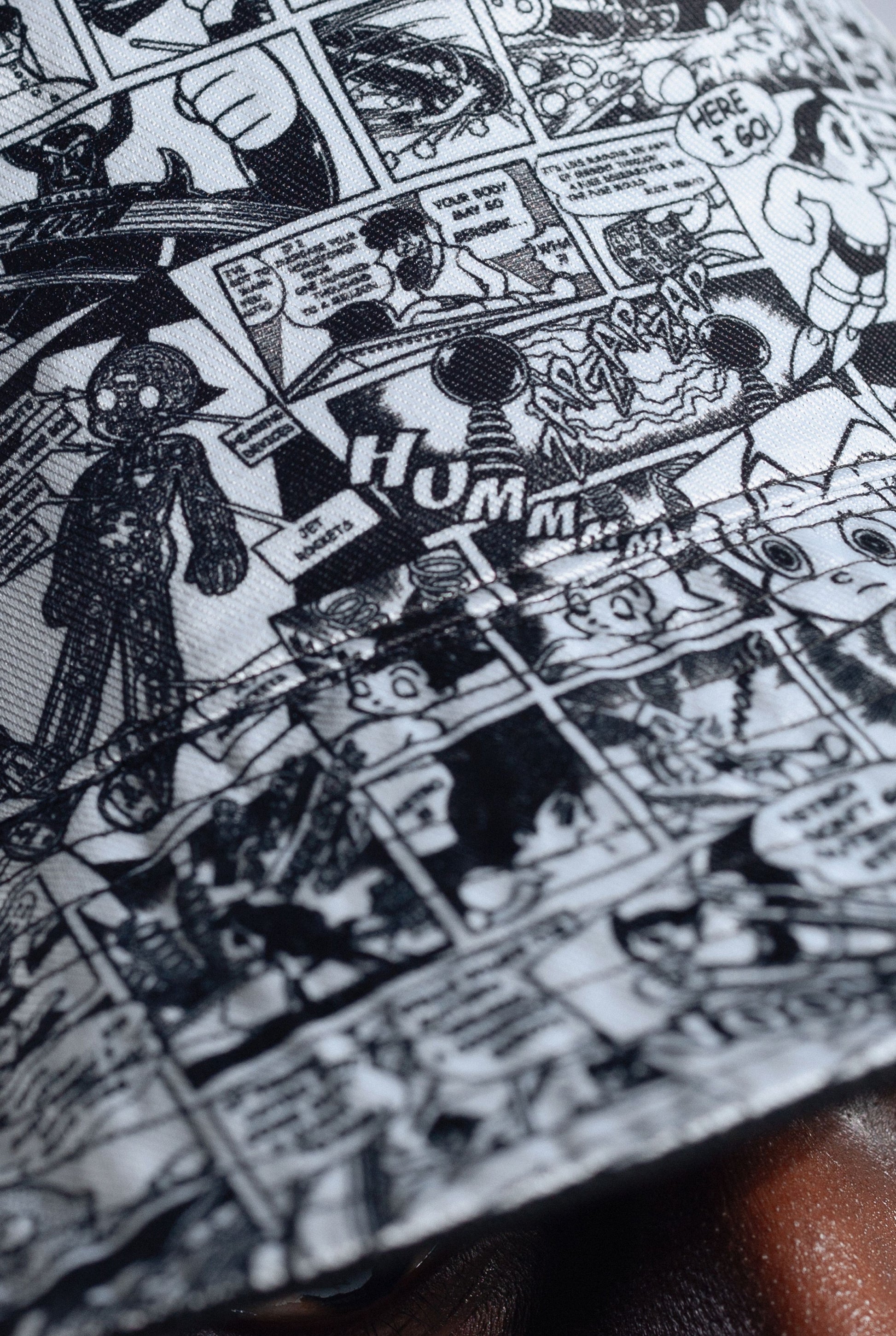 Close-up of Astro Boy comic book style pattern with black and white illustrations.