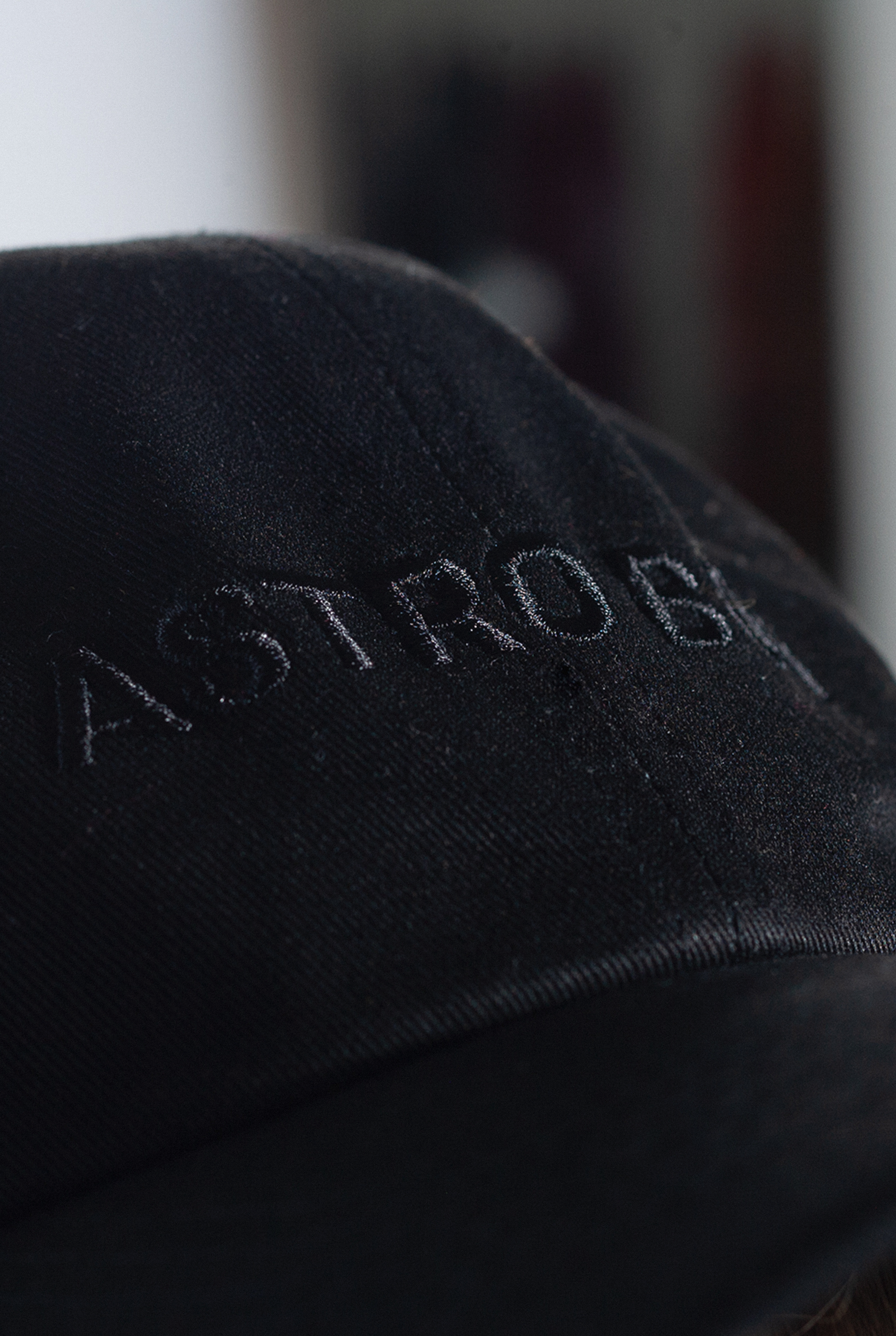 Close up of Black Astro Boy cap with embroidered Astro Boy text in black