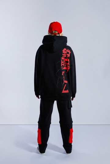 Back of model wearing black Astro Boy End Credits hoodie. Large red Astro Boy text in Japanese with an embroidered Astro Boy silhouette over the top