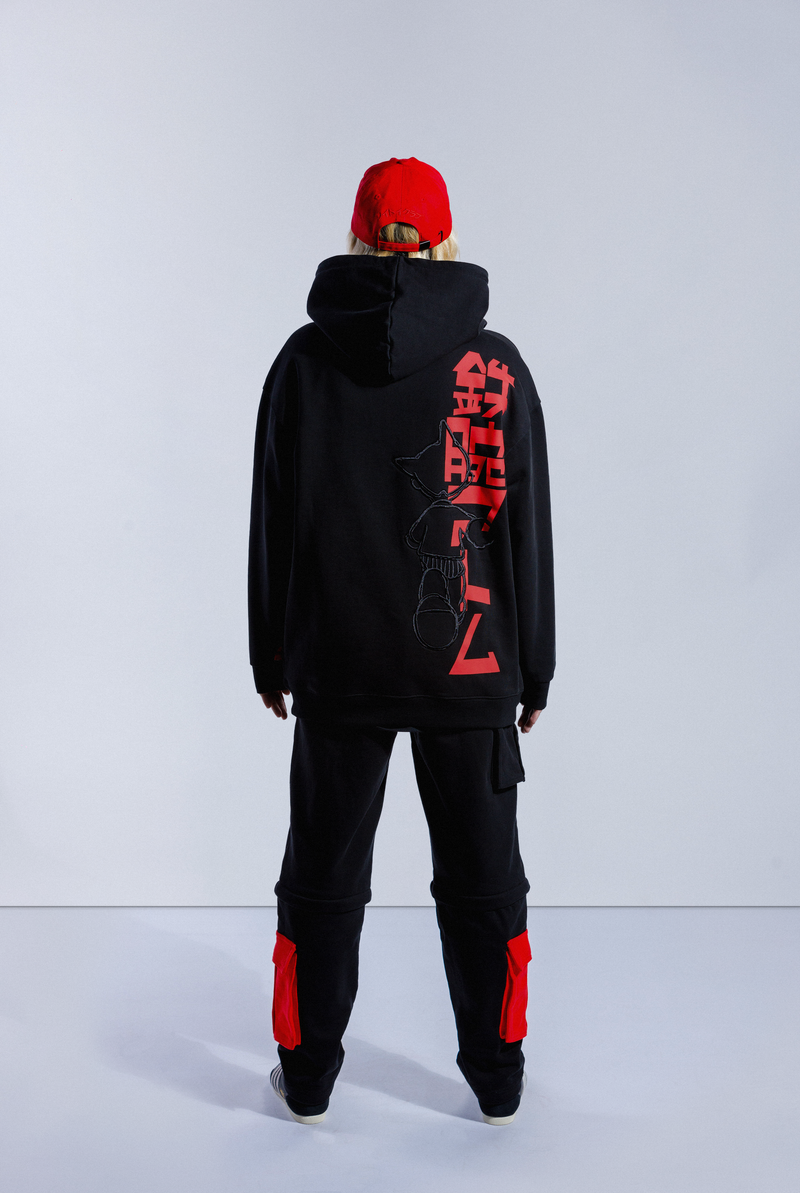 Back of model wearing black Astro Boy End Credits hoodie. Large red Astro Boy text in Japanese with an embroidered Astro Boy silhouette over the top