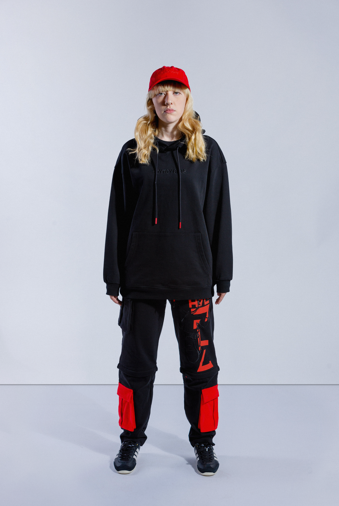 Back of model wearing black Astro Boy End Credits hoodie. Large red Astro Boy text in Japanese with an embroidered Astro Boy silhouette over the top