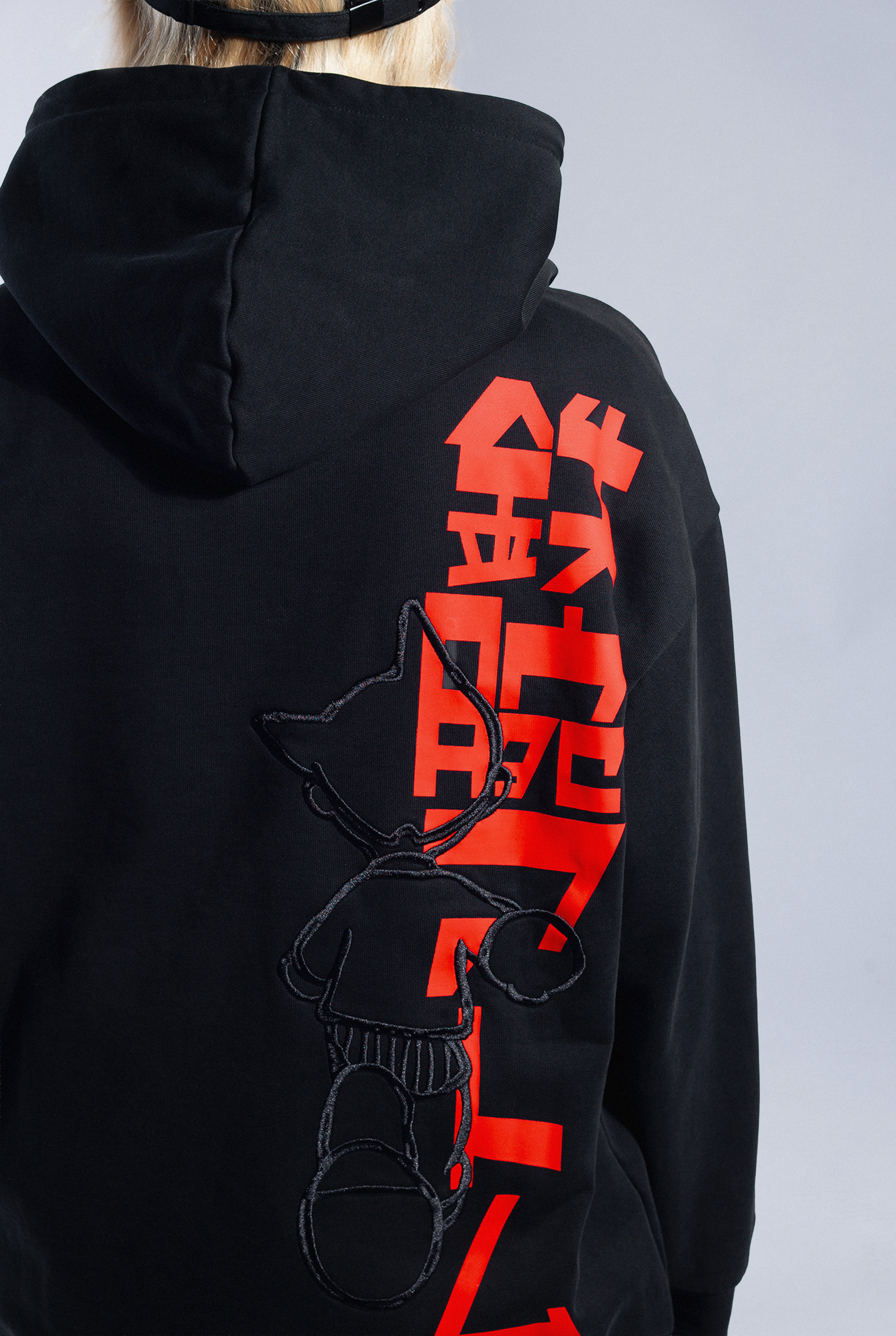 Close up of End Credit Hoodie. Show red screenprint Astro Boy logo with embroidered Astro Boy design over the top