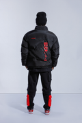 Back of model wearing black Astro Boy puffer. Back features stitched Astro Boy head silhouette 