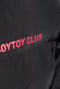 Detail shot of red 'SOYTOY CLUB' text on black puffer jacket