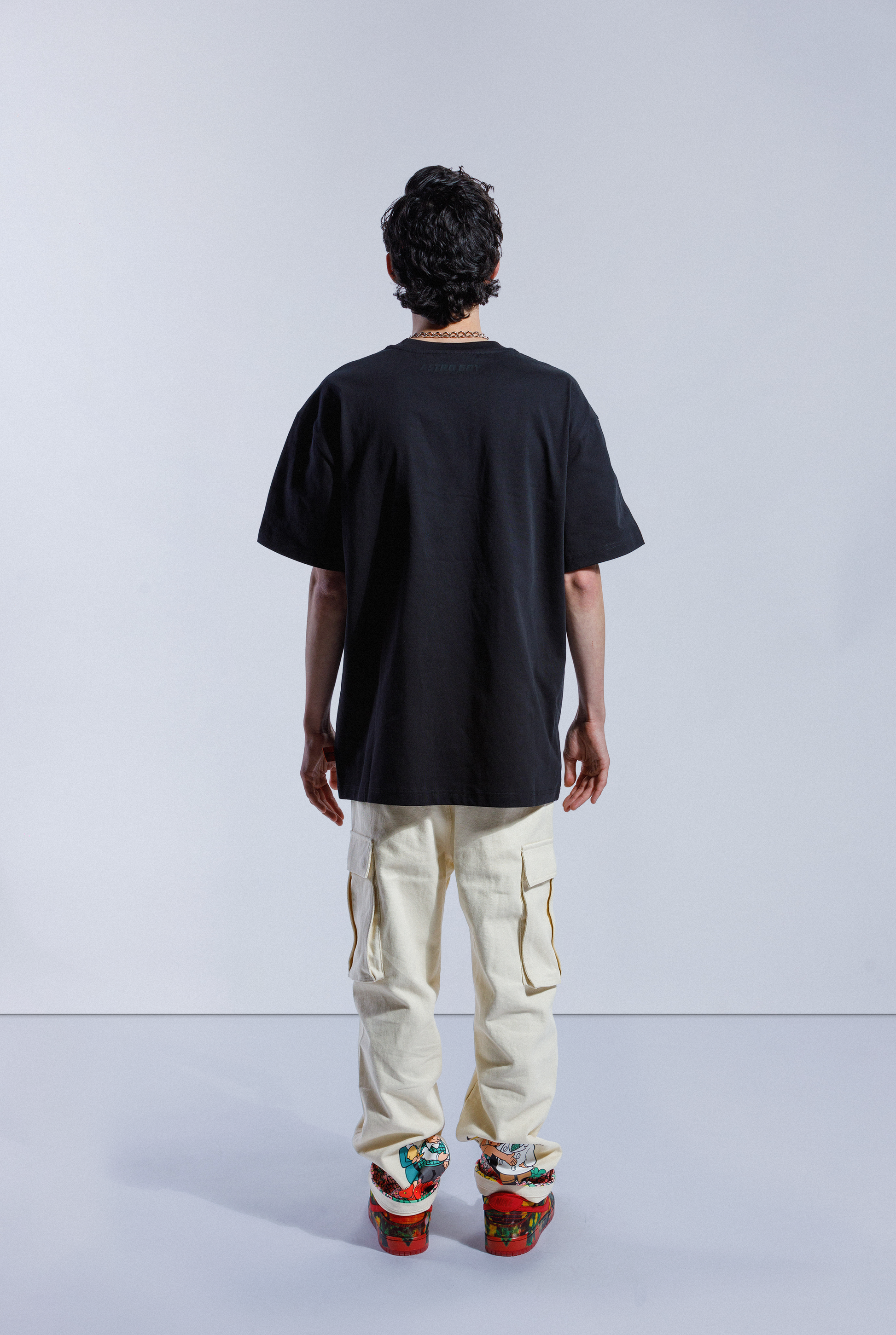 Back of model in Astro Boy Flight Tee.