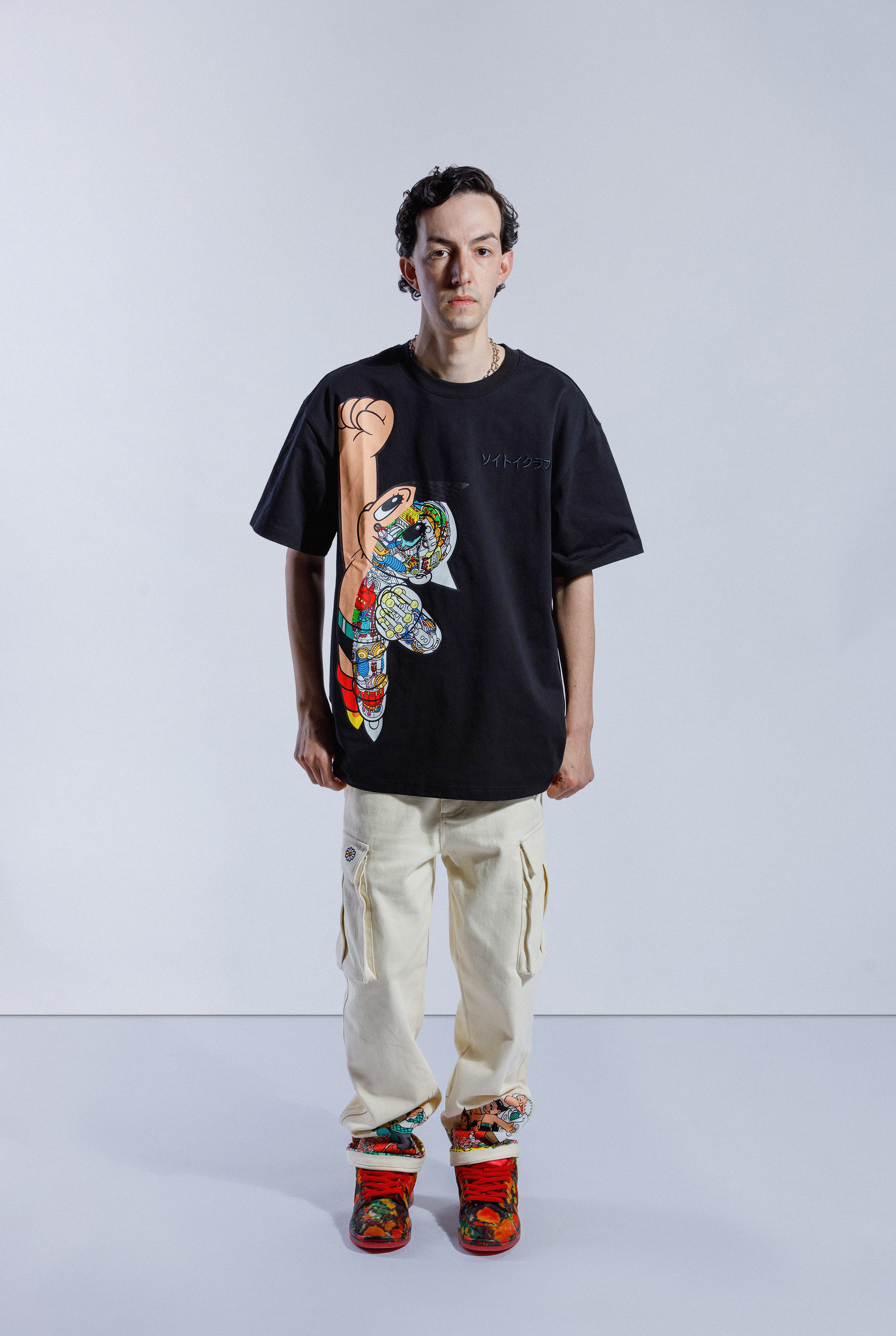 Model wears black Astro Boy Flight Tee. Large Astro Boy graphic on the left side in a flying motion