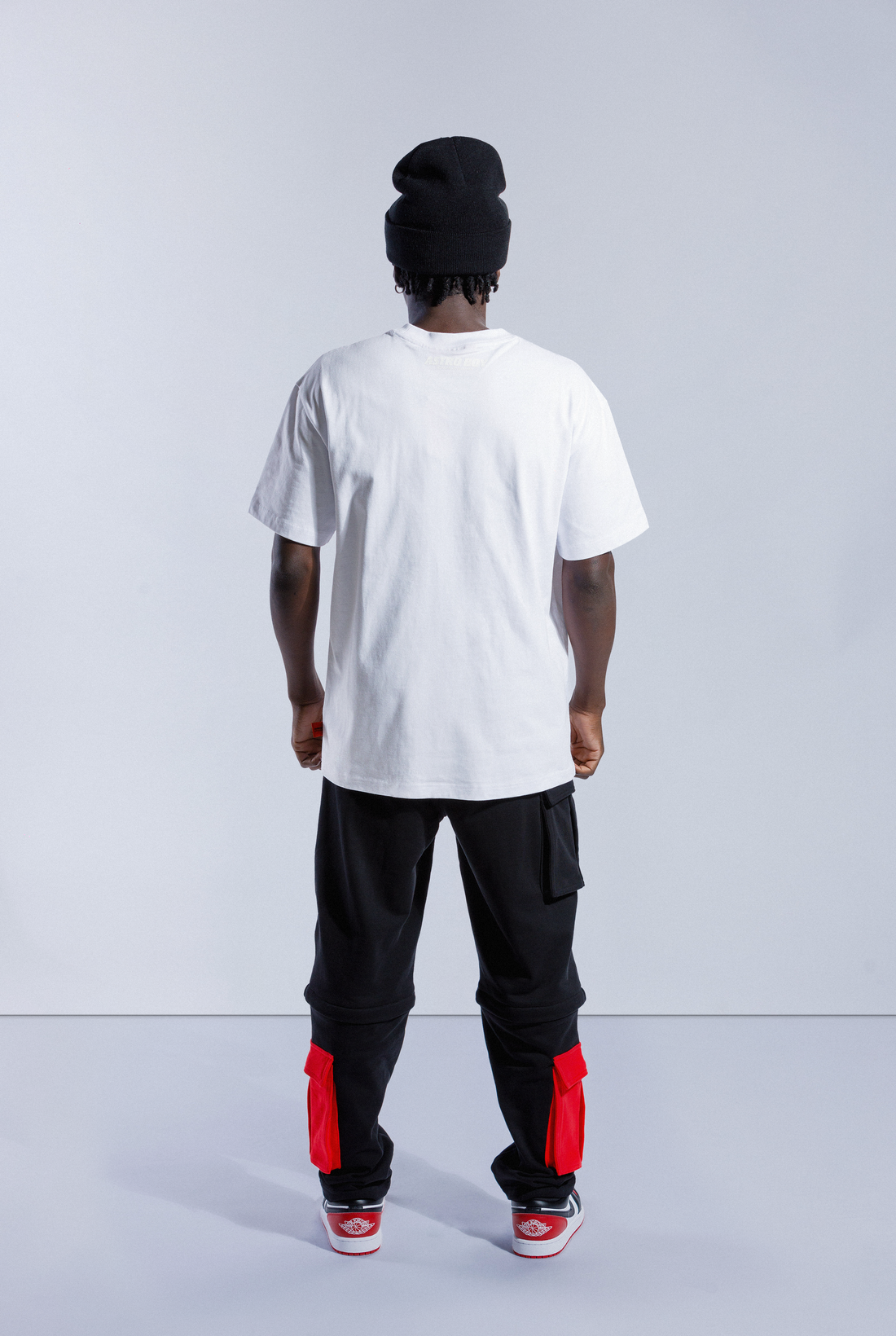 Model wears white Astro Boy Flight Tee. Large Astro Boy graphic on the left side in a flying motion