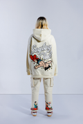Back of model wearing Sleepy Boi hoodie. Shows large Soytoy Club text with chenille embroidered Astro Boy sleeping in a field of stars