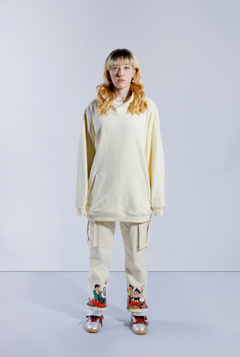 Model wearing Sleepy Boi hoodie. Has white SOYTOY CLUB embroidered on front