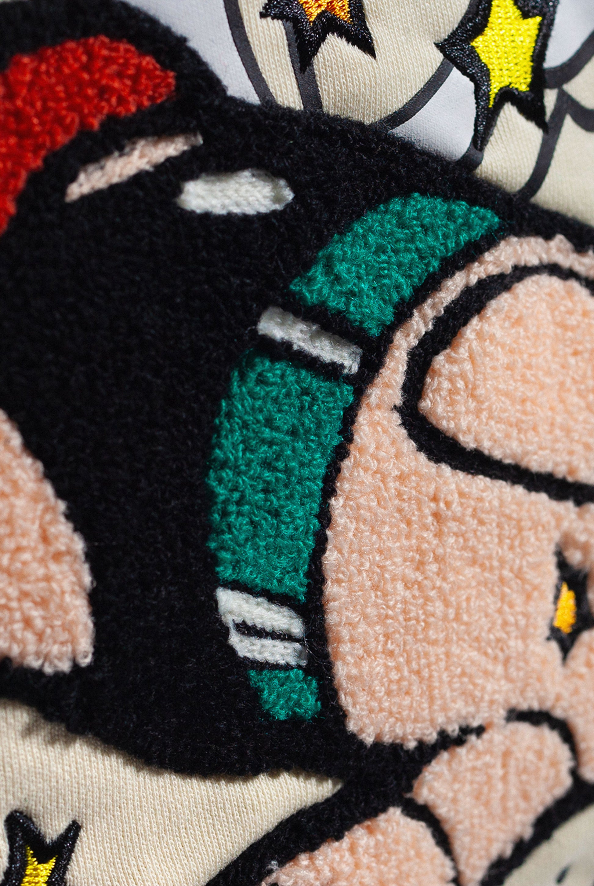 Close up of chenille embroidered Astro Boy sleeping in a field of stars