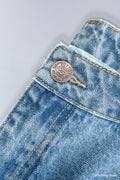 Close up of metal buttons with 'Soytoy Club Denim' branding