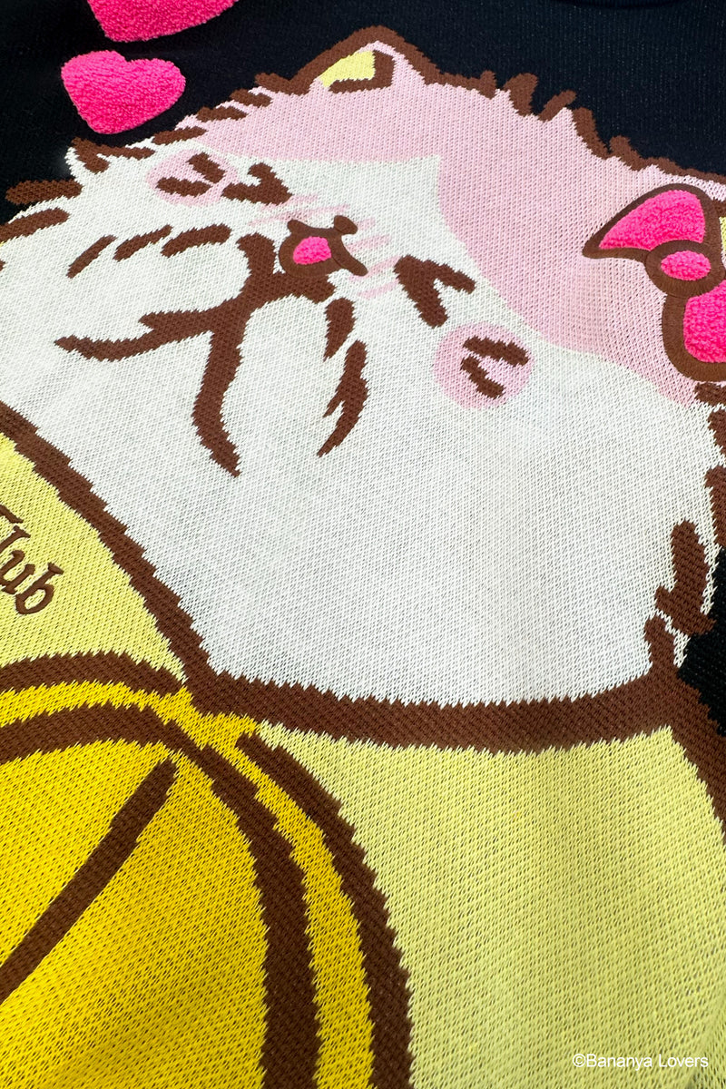 Close up of black knit Bananya sweater. shows knit detail and raised fluffy bow and hearts on design