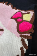 Close up of black knit Bananya sweater. shows raised fluffy bow 