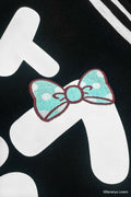 Detail shot of Bananyako Seifuku showing back of sailor flap with text that reads 'SOYTOY CLUB' and an embroidered blue Taremimi Bananya bow