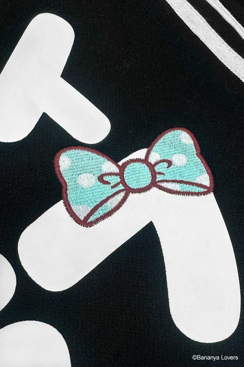 Detail shot of Bananyako Seifuku showing back of sailor flap with text that reads 'SOYTOY CLUB' and an embroidered blue Taremimi Bananya bow