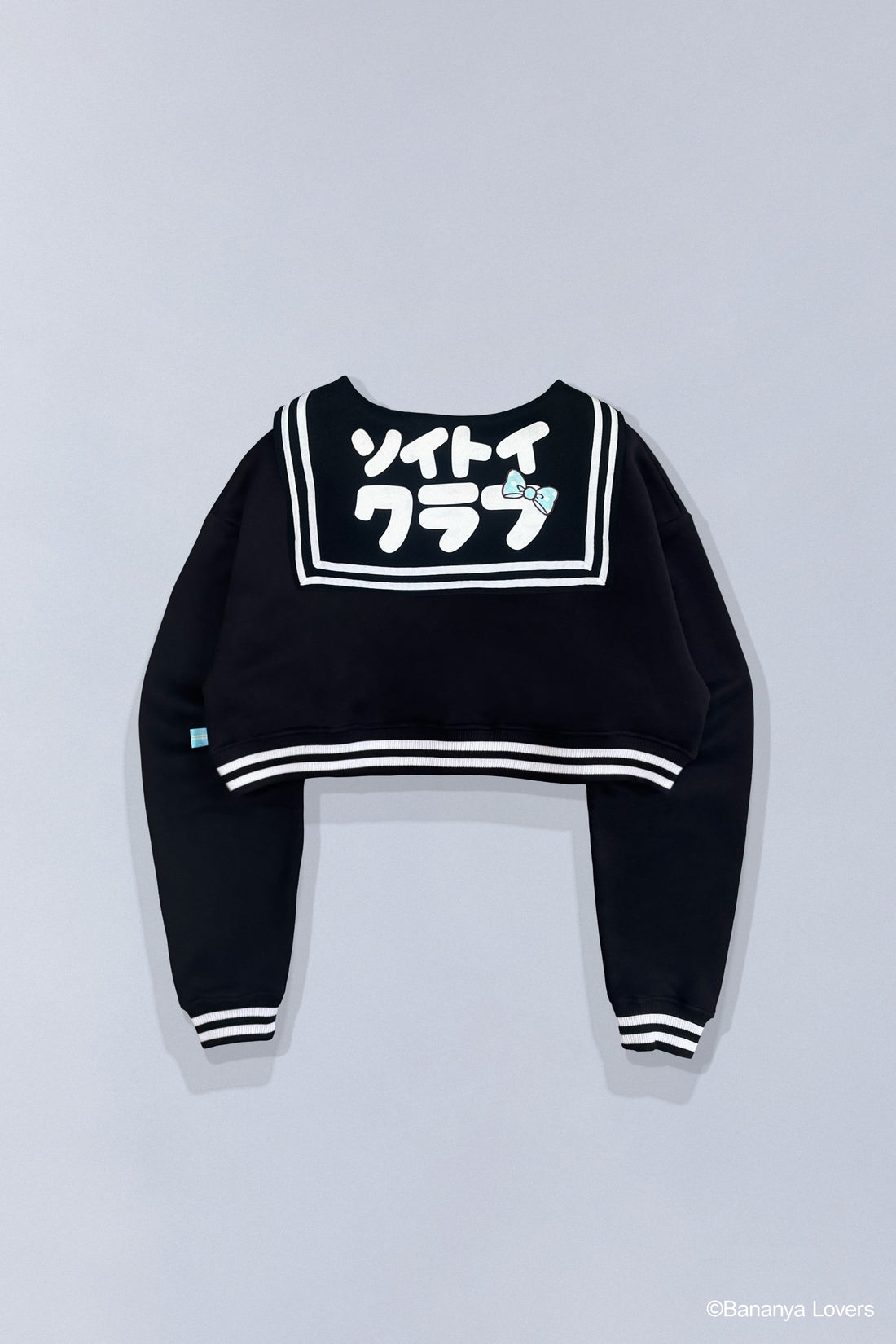Back view of Bananyako SOYTOY CLUB cropped Seifuku sailor-style sweater. Sailor flap has Japanese text that reads 'soytoy club' with a Taremimi Bananya bow on it