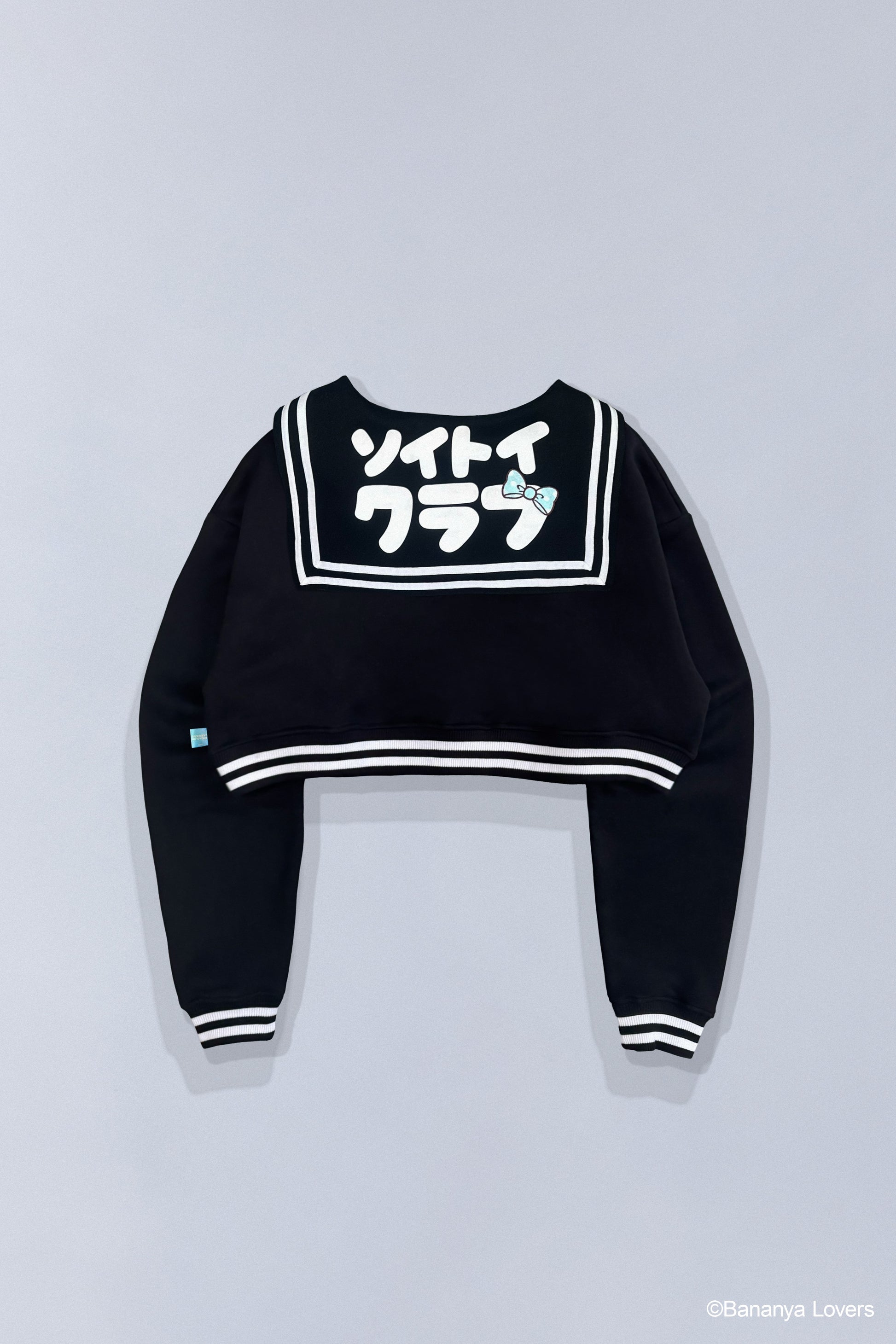 Back view of Bananyako SOYTOY CLUB cropped Seifuku sailor-style sweater. Sailor flap has Japanese text that reads 'soytoy club' with a Taremimi Bananya bow on it