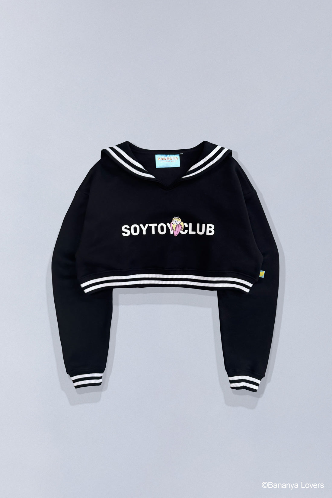 Back view of Bananyako SOYTOY CLUB cropped Seifuku sailor-style sweater. Sailor flap has Japanese text that reads 'soytoy club' with a Taremimi Bananya bow on it