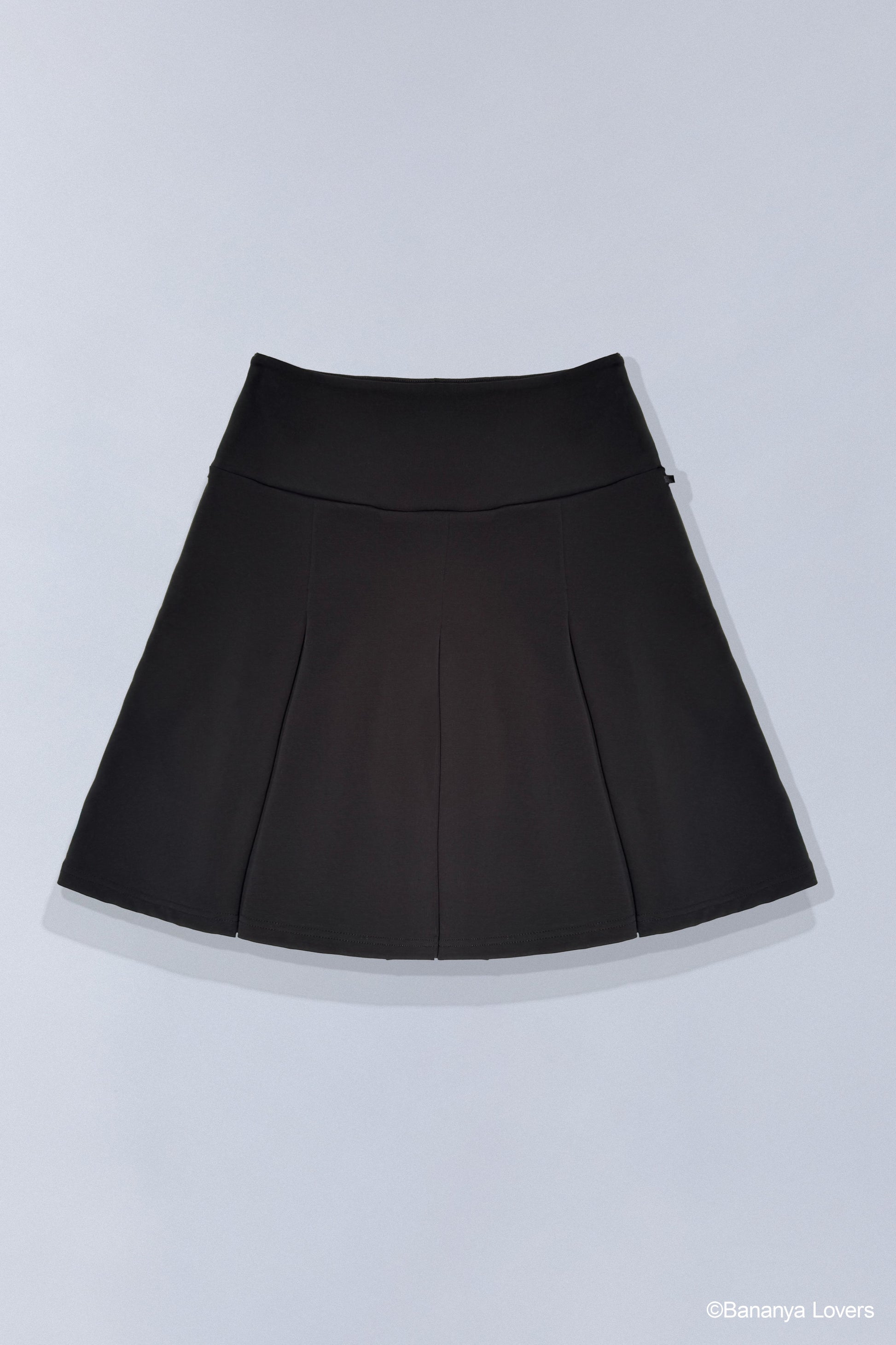 Back of black pleated Taremimi Bananya skirt on grey background.