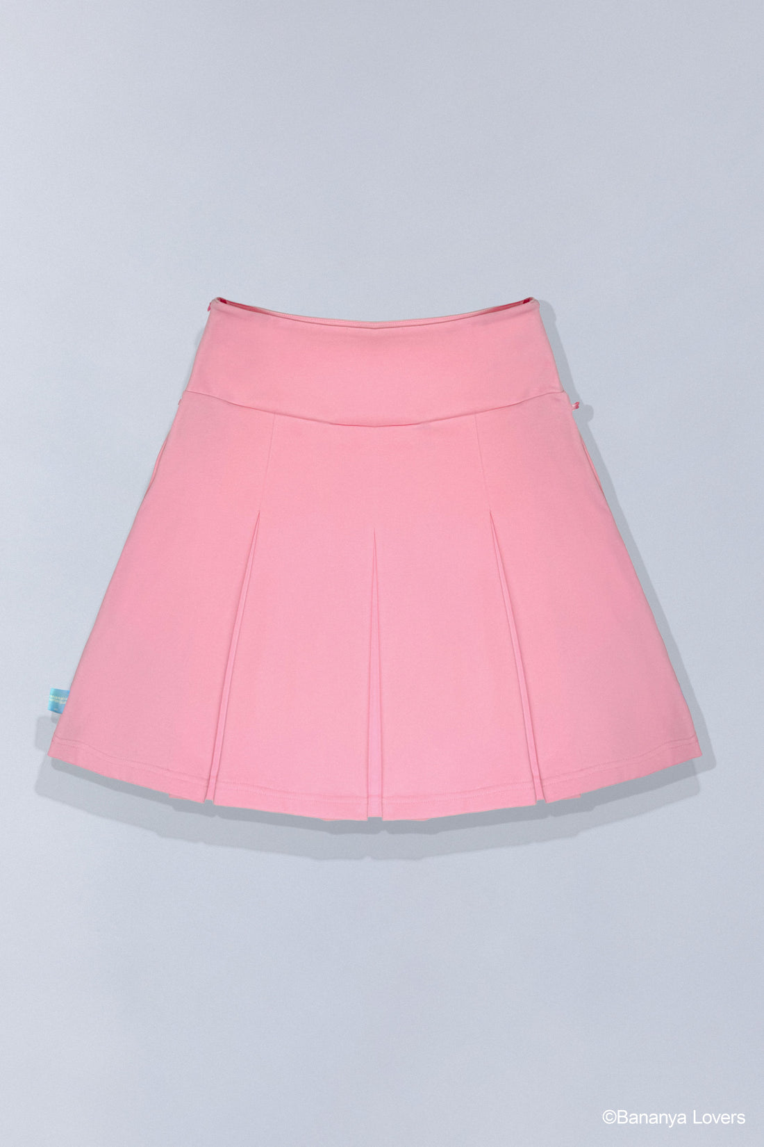 Pink pleated Bananya skirt with a small Bananya embroidered on bottom left