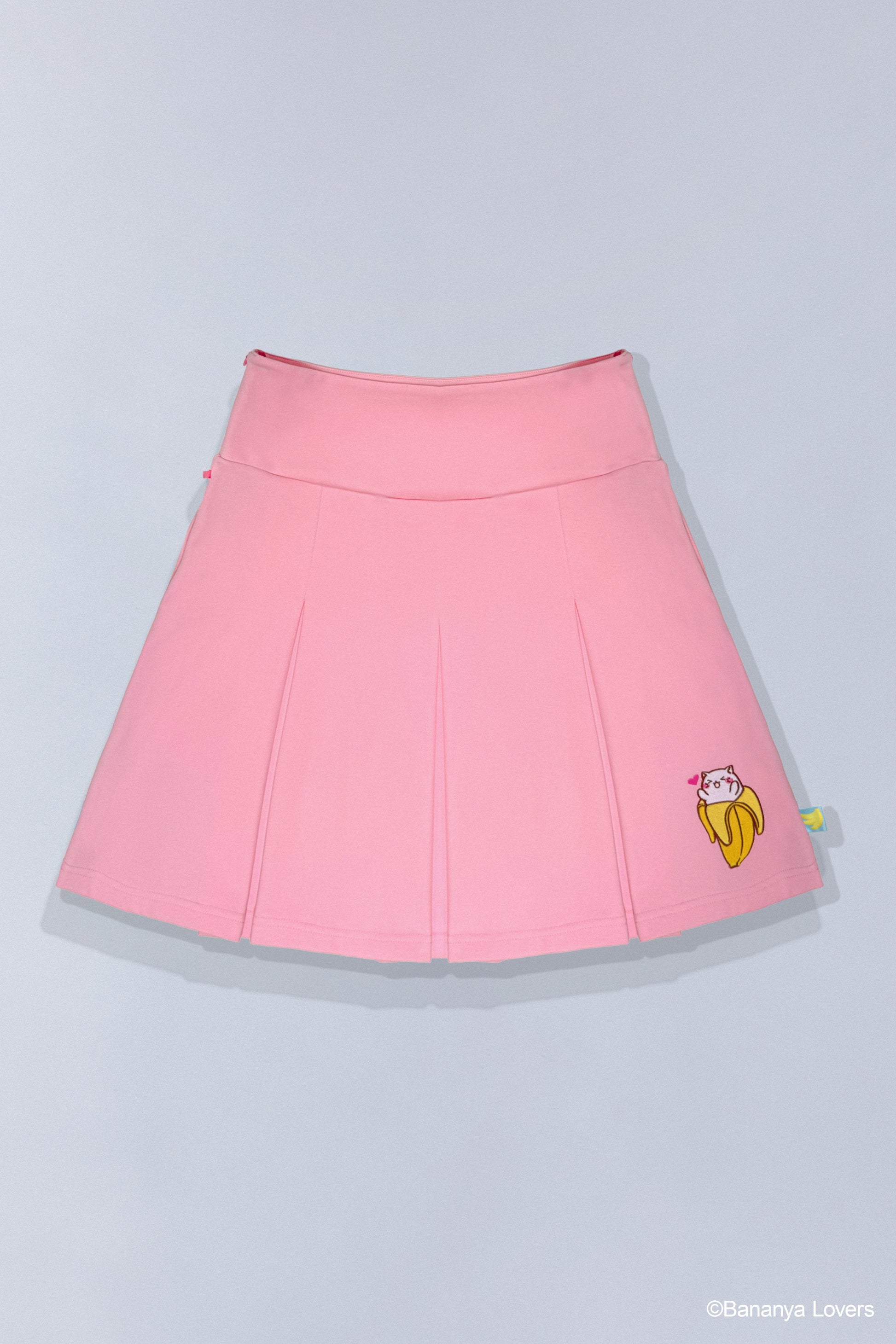 Pink pleated Bananya skirt with a small Bananya embroidered on bottom left