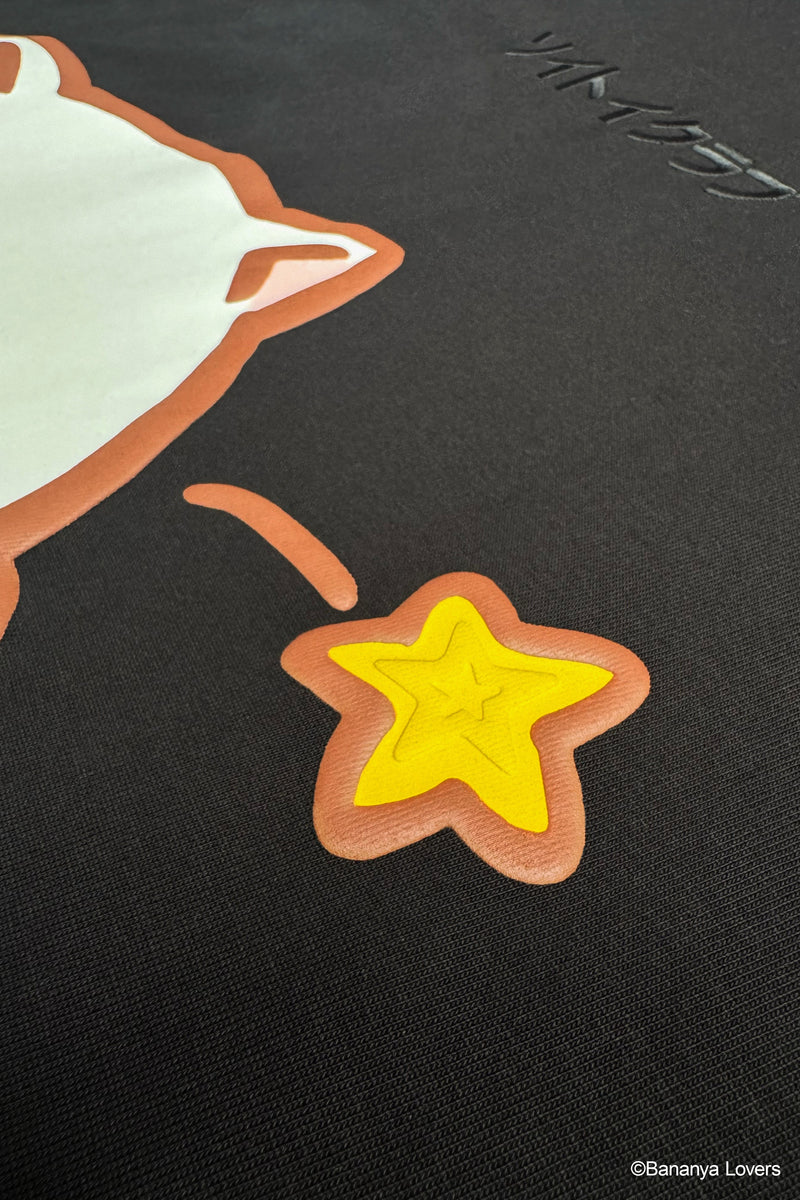 Close up puff print detail of black Bananya t-shirt showing star used on design