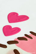 Detail shot of white Bananyako t-shirt. Shows love hearts from design with a raised puff print edge